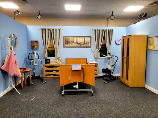 A photo of the bedroom set in the film studio with the bed, drawers, wardrobe, and hoists.