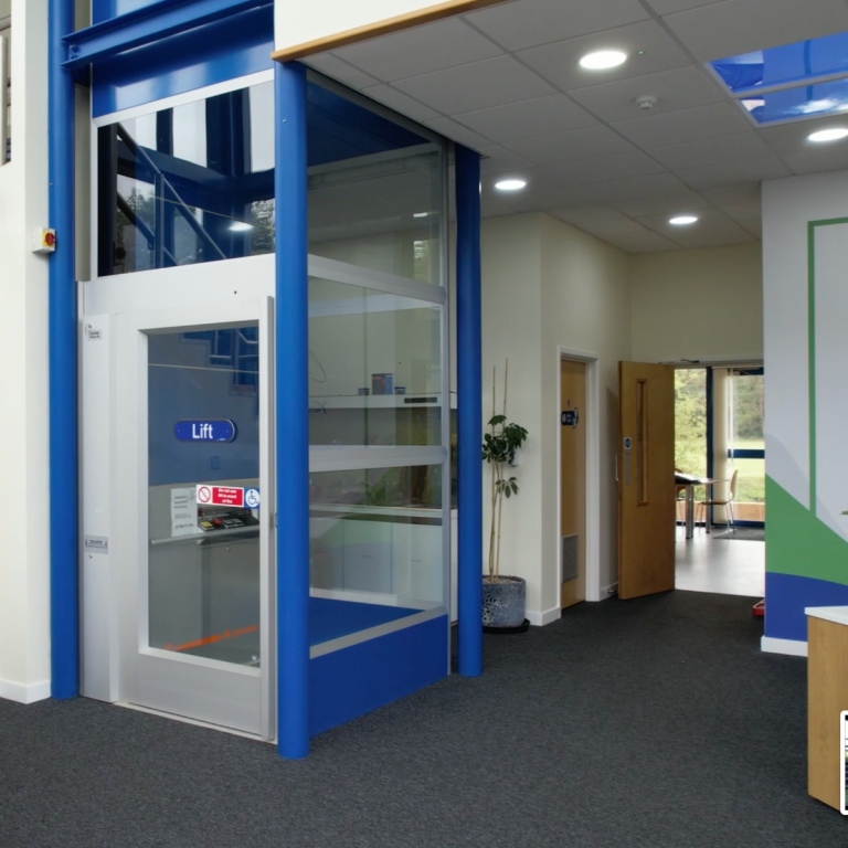 A photo of a reception area and the disability access lift to the first floor.