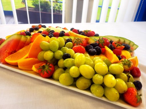 A photo of a fresh fruit platter with grapes, strawberries, watermelon, and more.