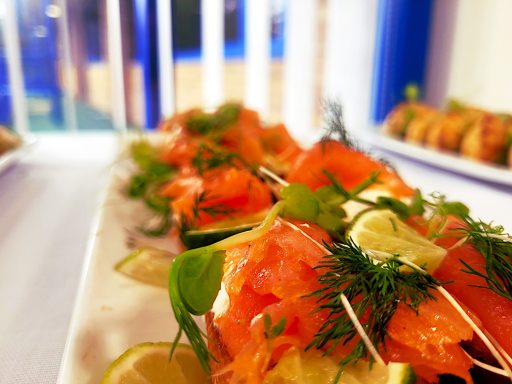 A close up of smoked salmon and cream cheese crostini