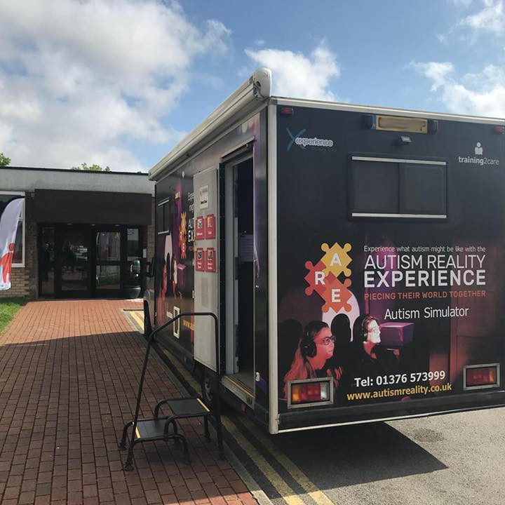 A photo of one of the mobile Autism Reality Experience vans outside a venue.