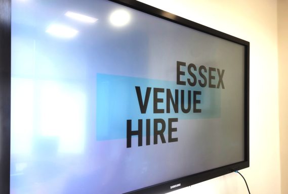 A close up photo of the smart screen TV in the boardroom with the Essex Venue Hire logo on the screen.