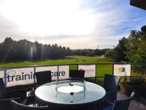 A view from the private terrace on the balcony of the boardroom. Outdoor seating and a round table looking over the golf course.