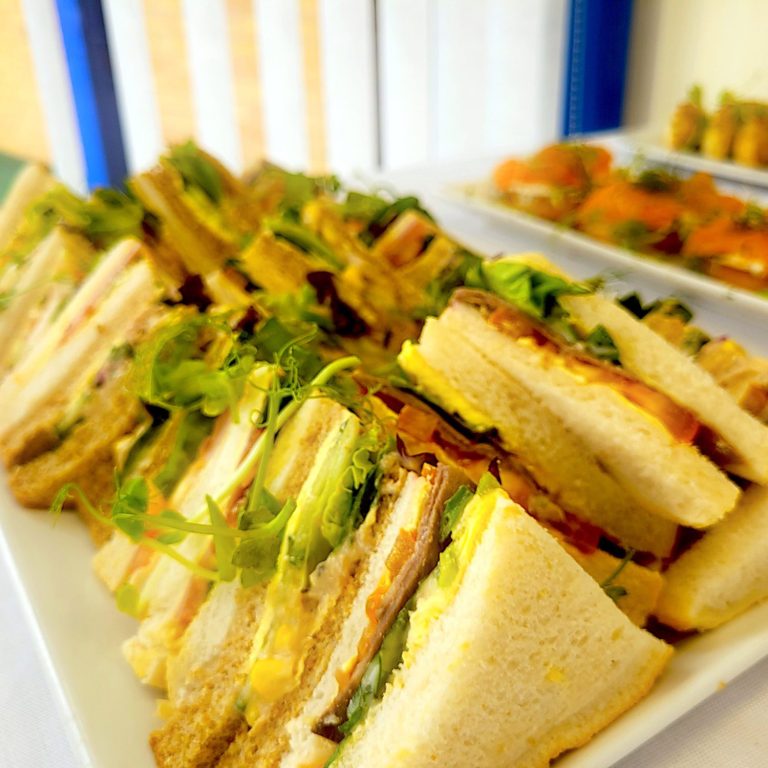 A close up photo of a sandwich platter with various sandwich options.