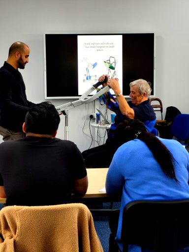 A close up photo of the trainer being helped out of a seat in the training demonstration.