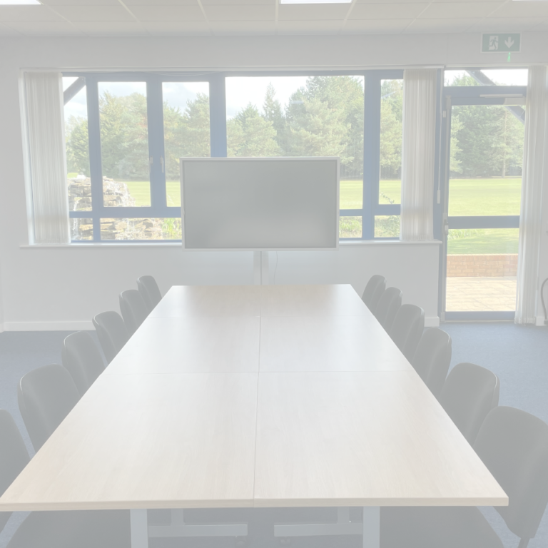 Faded image of a meeting room laid out in a boardroom style with a 65" smart screen in front of a window with a view of trees and a golf course.